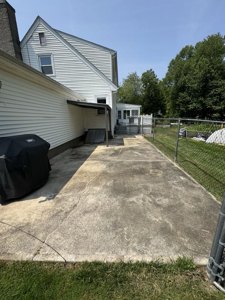Concrete patio before, stained and weathered