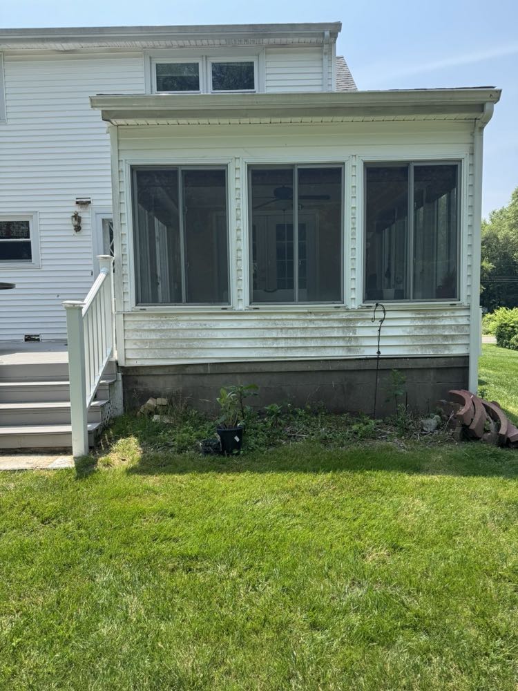 House siding before, covered in dirt and algae